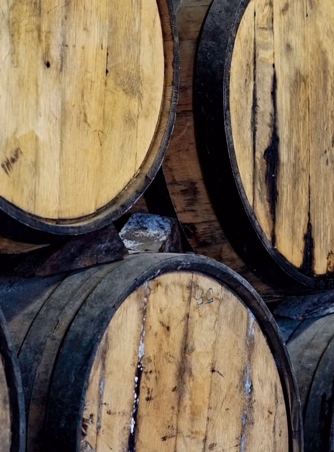 A stack of oak barrels in a barrel room